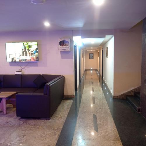 a living room with a couch and a hallway at Hotel Shubh Ashish Near Bank More in Dhanbād