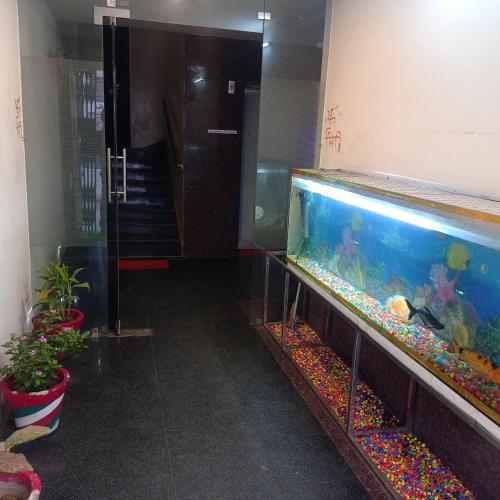 a large aquarium in a room with a hallway at Hotel Shubh Ashish Near Bank More in Dhanbād
