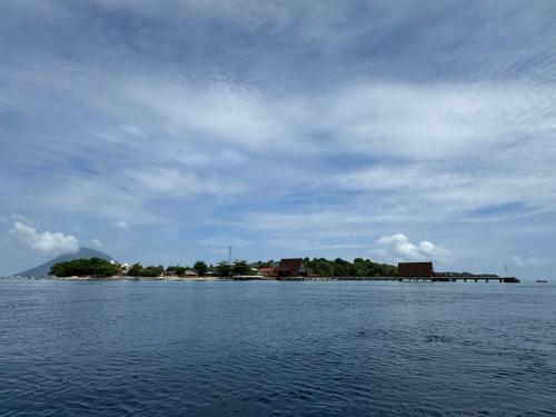 an island in the middle of a large body of water at MC Bunaken Stay Diving Trip's in Bunaken
