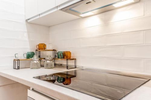 a kitchen with white walls and a counter at Holiday Home i Cervi in Rome