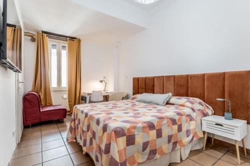 a bedroom with a large bed and a red chair at Holiday Home i Cervi in Rome