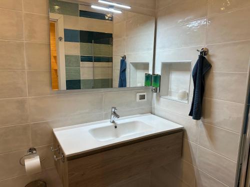 a bathroom with a sink and a mirror at B&B Casa Limone in Limone sul Garda