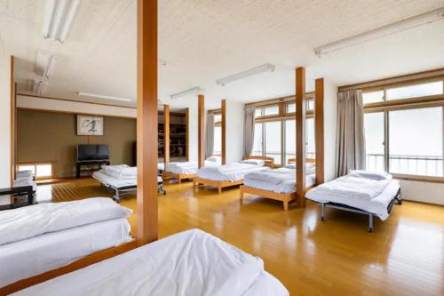 a room with a bunch of beds in it at ザホテル湯沢パラディーソ in Yuzawa