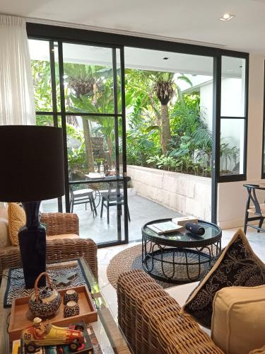 a living room with a couch and a table at Martini Suite and Villa in Kerobokan