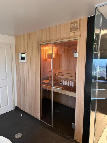 a bathroom with a glass shower and a sink at Ferienhof A&B Wellness Villa 12 personen in Bullange