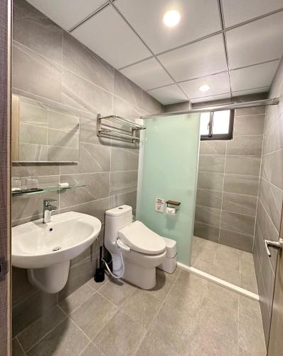 a bathroom with a toilet and a sink at Salt&Light Inn in Magong