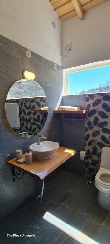 a bathroom with a sink and a mirror at The Pluck Homestay- Umagarh in Rāmgarh