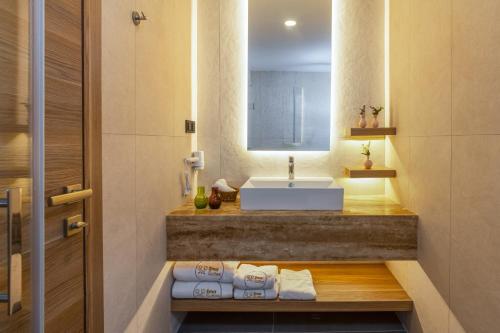 a bathroom with a sink and a counter with towels at Ema Houses in Antalya