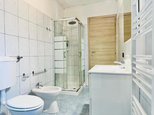 a bathroom with a toilet and a sink and a shower at Piccola Luna in Menaggio