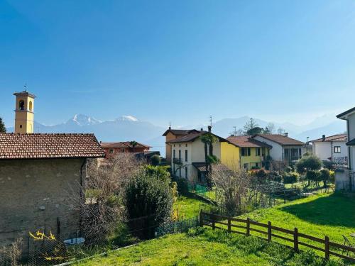 a village with houses and a fence and a church at Piccola Luna in Menaggio