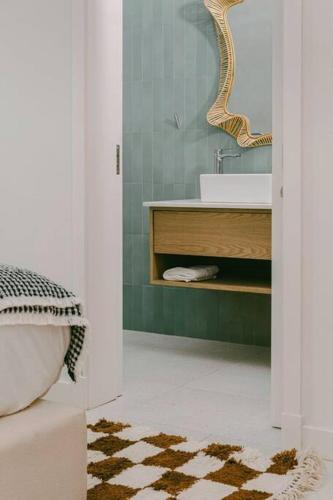 a bathroom with a sink and a mirror at Tamarin Sunset Beach V in Tamarin