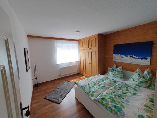 a bedroom with a large bed and a window at Apartment Gertrude in Sankt Johann in Tirol