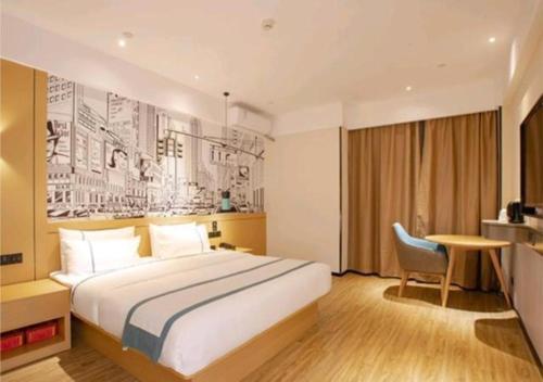 a hotel room with a large bed and a desk at City Comfort Inn Haikou Zhongjie Road Walking Street in Haikou