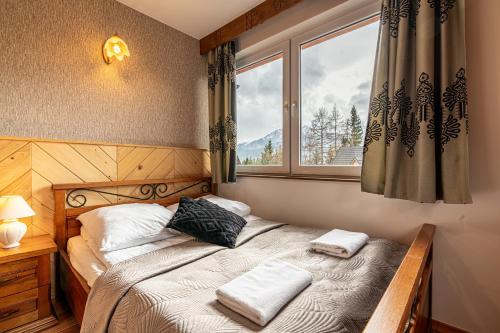 Posteľ alebo postele v izbe v ubytovaní Apartamenty pod Słońcem