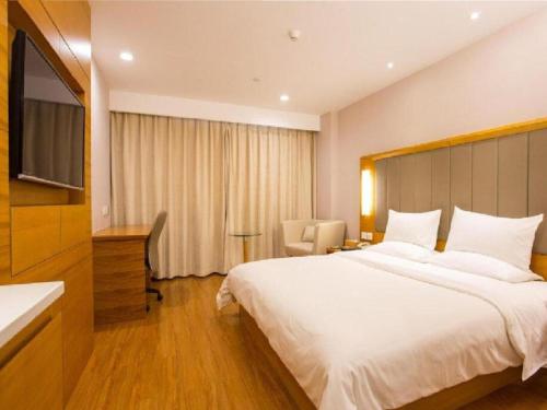 A bed or beds in a room at JI Hotel Hangzhou Huanglong Wensan Road