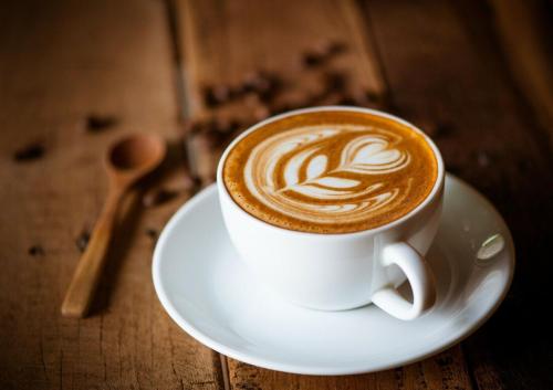 a cup of coffee on a plate on a table at La Casona de Revolgo in Santillana del Mar
