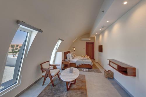 a bedroom with a bed and a large window at Western Hotel Liwa in Liwa