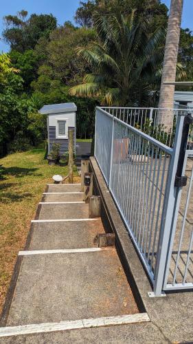 a group of stairs next to a fence at Rainforest Cottage in Port Macquarie