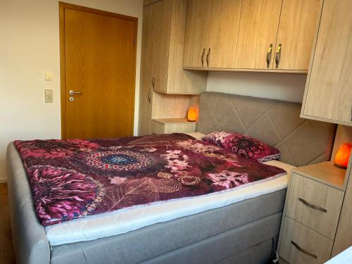 a bedroom with a bed with a colorful blanket on it at TOP Ferienwohnung in Bad Urach