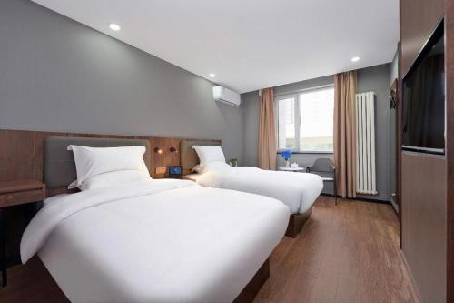 Tempat tidur dalam kamar di Nihao Hotel Beijing Lishui Bridge Metro Station