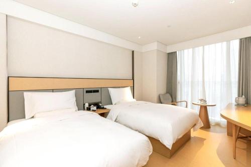Ein Bett oder Betten in einem Zimmer der Unterkunft Ji Hotel Chengdu Taikoo Li