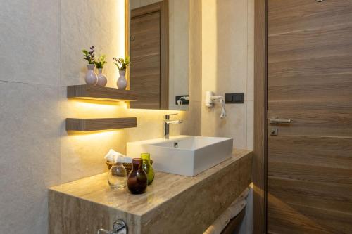 a bathroom with a white sink and a mirror at Ema Houses in Antalya