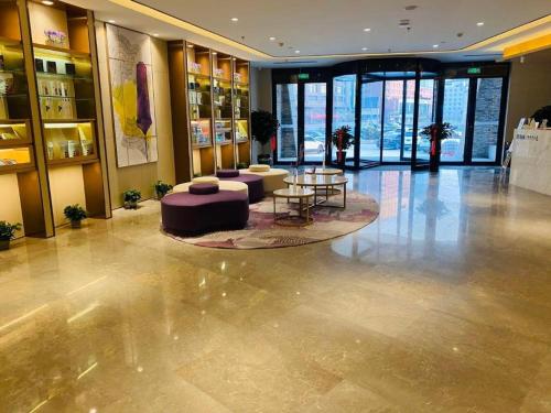 a lobby with a couch and a table in a building at Lavande Hotel Changchun Gaoxin Jilin University in Changchun