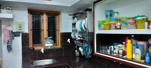 a kitchen counter with a sink and a mirror at VIBGYOR HOME AWAY FROM HOME in Kānnangād