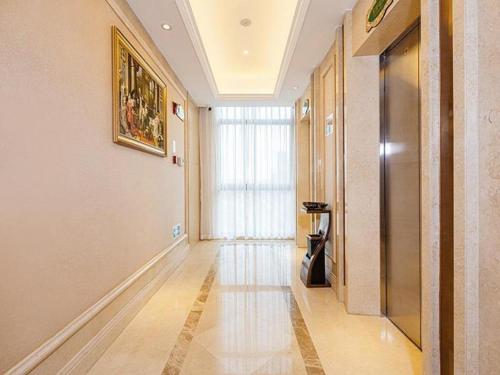 a hallway with a large window in a building at Vienna Hotel Chongqing Jiangjin Shuangfu in Zouma