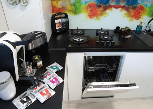 a kitchen with a counter with a stove top oven at Oltenia Studio Happy Residence Craiova in Craiova