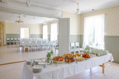 a table with food on it in a large room at Hotel Norrvalla in Vöyri