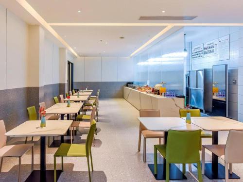 a row of tables and chairs in a restaurant at Borrman Hotel Chongqing Bishan Central Street in Chongqing