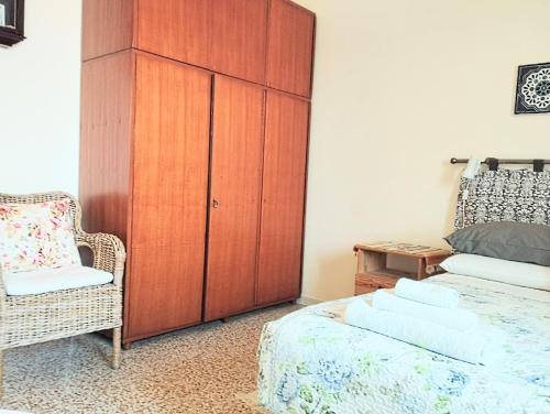 a bedroom with a cabinet and a bed and a chair at Private room and bathroom close to Piazzale Roma in Venice Mestre in Mestre