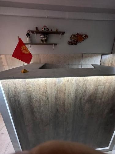 a counter top with a flag on top of it at Holy Moly Hostel in Bishkek