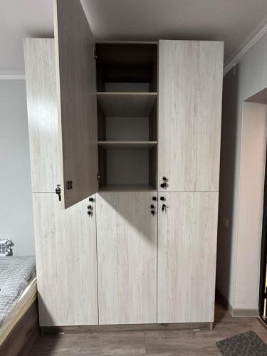 a large wooden cabinet in a room at Holy Moly Hostel in Bishkek