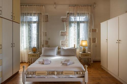 a bedroom with a bed with two towels on it at Mar Traditional Mansion in Arónion