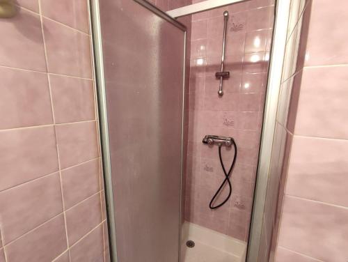a shower with a glass door in a bathroom at Appartement au centre de TREBEURDEN et à 500m de la plage - Ref 665 in Trébeurden