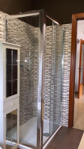 a shower with a glass door in a bathroom at B&B IL QUADRIFOGLIO in Iesi
