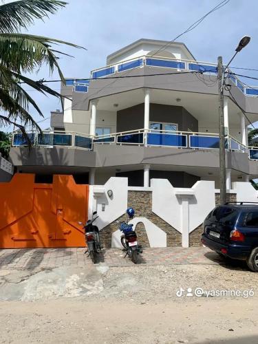 a motorcycle parked in front of a house at RÉSIDENCES ORI in Cotonou