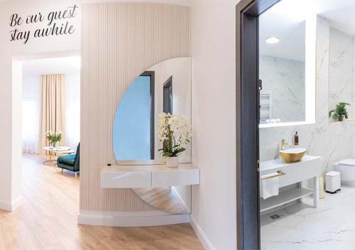 a bathroom with a sink and a mirror at Atostogų Parkas Hotel in Palanga