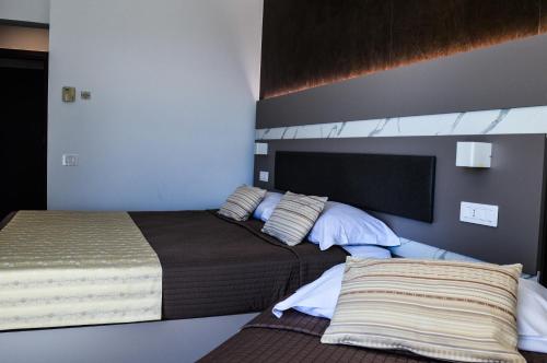 a bedroom with two beds and a mirror at Mediterranea Hotel & Convention Center in Salerno