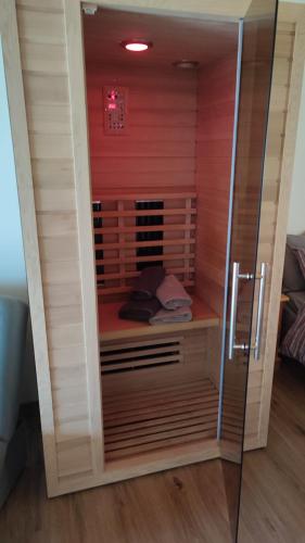 a walk in shower in a room with red walls at Ai Monti in Barcis