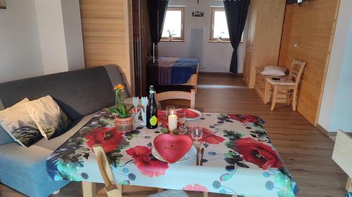 a living room with a table with a heart on it at Ai Monti in Barcis
