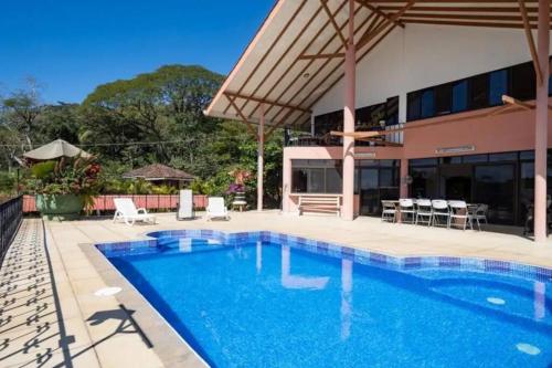 a swimming pool in front of a building at 6 Cute studio, GREAT location, close to beach! With AC! in Carrillo