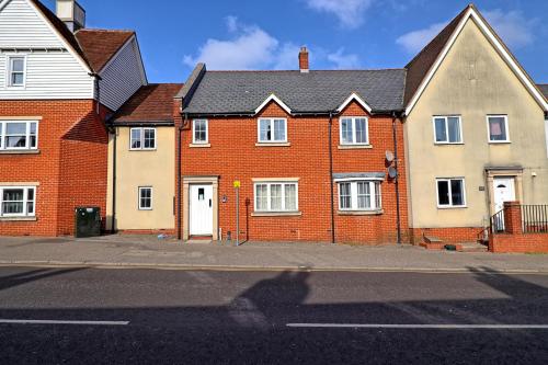 a row of brick houses on a street at Hythe Hill Home in Colchester