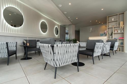 a restaurant with chairs and a table in a room at SAVOIE Apartments Bukovel in Bukovel