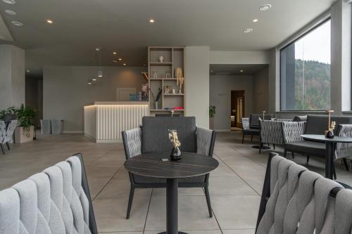 a waiting room with chairs and a table at SAVOIE Apartments Bukovel in Bukovel