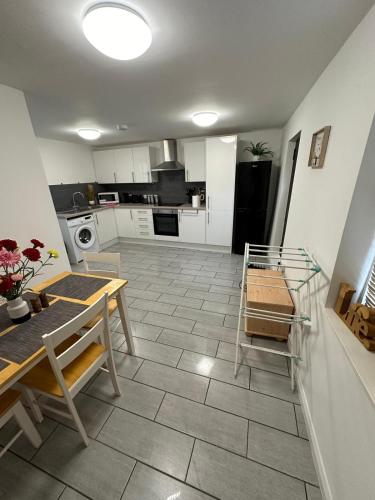 a kitchen with a table and a dining room at Comfort in Colchester