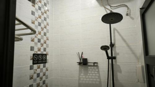 a shower with a shower head in a bathroom at Premier Homestay Syariah in Kalasan