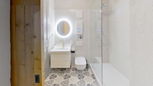 a bathroom with a toilet and a sink and a shower at Pebbles Suiten by RiNG in Regensburg